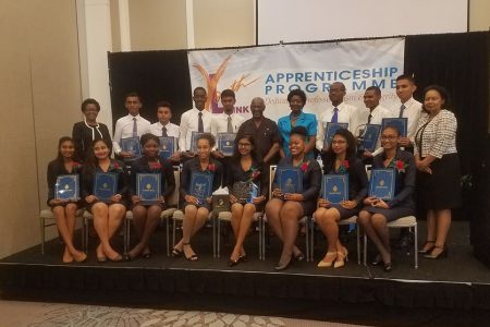 The apprentices posed for a photo with acting Managing Director, Denise Hobbs (standing at left), Minister within the Ministry of Social Protection, Keith Scott (sixth from right, standing) and Patrice La Fleur Secretary, General of UNESCO (standing at centre)