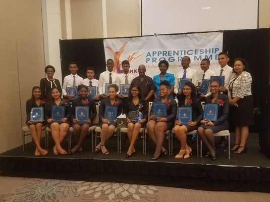 The apprentices posed for a photo with acting Managing Director, Denise Hobbs (standing at left), Minister within the Ministry of Social Protection, Keith Scott (sixth from right, standing) and Patrice La Fleur Secretary, General of UNESCO (standing at centre)