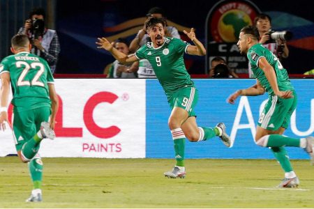 Algeria’s Youcef Belaili celebrates scoring their first goal with Baghdad Bounedjah and Ismael Bennacer. (REUTERS/Amr Abdallah Dalsh)