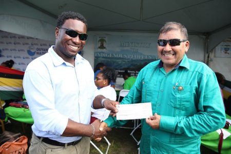 Minister of Indigenous Peoples’ Affairs, Sydney Allicock (right) handing over the cheque to Chairman of the Agatash Community Development Council (CDC), Mark Ambrose. (DPI photo)
