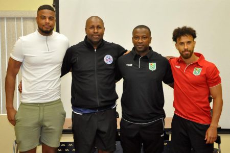 Calm before the Storm-Golden Jaguars head-coach Michael Johnson [2nd from right] and team captain Samuel Cox [right] posing with Bermuda’s coach Kyle Lightbourne [2nd from left] and skipper Dante Leverock following the conclusion of their press conference ahead of their international friendly tomorrow.
