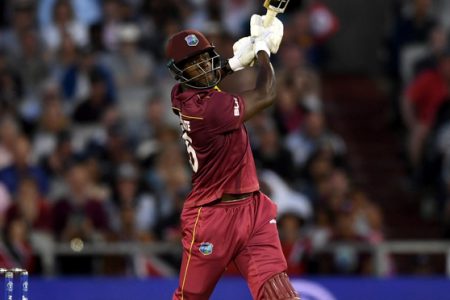 West Indies’ Carlos Brathwaite goes on the attack during his 101 against New Zealand at Old Trafford.