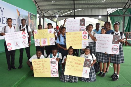The Ministry of Social Protection’s Department of Labour and the Ministry of Education observed World Day Against Child Labour yesterday at D’Urban Park, Georgetown.
According to the Department of Public Information, more than forty students from the Kingston and Carmel Secondary Schools participated in the exercise, raising their voices against Child Labour.
Students from Carmel Secondary School depicting placards on Child Labour. (DPI photo)
