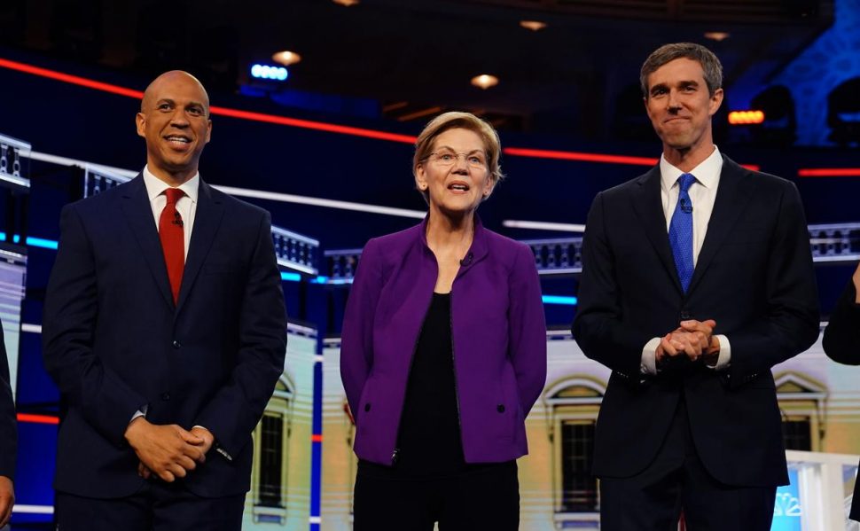 From left: U.S. Senator Cory Booker, U.S. Senator Elizabeth Warren and former U.S. Rep. Beto O’Rourke pose together before the start of the first U.S. 2020 presidential election Democratic candidates debate in Miami, Florida, U.S., June 26, 2019. REUTERS/Carlo Allegri
