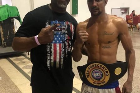 And The New! World Boxing Association Fedecentro and the Wold Boxing Council’s FECARBOX super flyweight champion, Elton ‘The Bully’ Dharry pose with Coach Don Saxby Coach following his unanimous decision win versus Gilberto Pedroza in his home country of Panama on Friday night.
