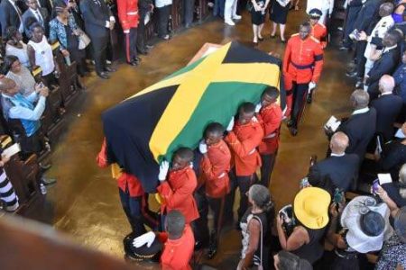 The bearer party takes the flag-draped coffin with the body of former Prime Minister Edward Seaga from the Cathedral of the Most Holy Trinity after yesterday's ecumenical service. (Photo: Michael Gordon) 