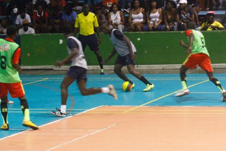 Jamal Cozier [2nd from right] of Future Stars attempting to engineer an attacking move against Tiger Bay at the National Gymnasium during their semi-final clash in the Corona Futsal Championships.

