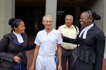 Azaad Ali, centre, is greeted by his attorneys Keisha Peters, left, and Renee Joseph at the Hall of Justice in Port-of-Spain, yesterday, after being freed after spending almost four months in prison in a mistaken identity case. Looking on is Ali's brother Anthony Marciano. (Photo: Trinidad Guardian)