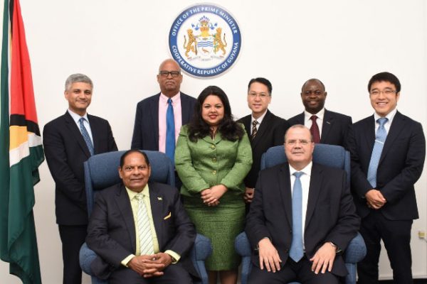 Prime Minister Moses Nagamootoo (seated at left) with some members of the IMF team. (Department of Public Information photo)
