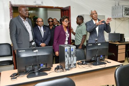 President David Granger (right) makes an inquiry during a tour of the Centre for Excellence in Information Technology, yesterday morning.  (Ministry of the Presidency photo)