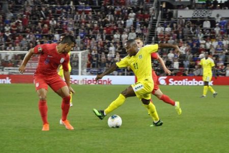 Callum Harriott [centre] of Guyana attempting to dribble Nick Lima of the USA at the Allianz Field in St. Paul, Minnesota during the CONCACAF Gold Cup