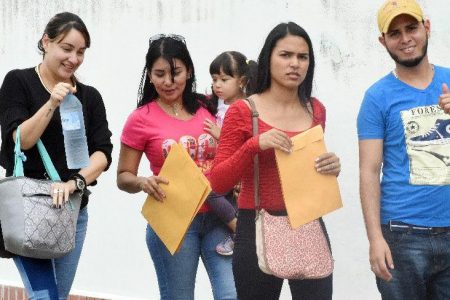 Hopeful Venezuelan applicants arrive for “Day 2” of Venezuelan registration process, Queen’s Park Oval on Saturday.