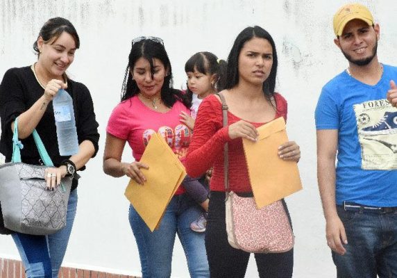 Hopeful Venezuelan applicants arrive for “Day 2” of Venezuelan registration process, Queen’s Park Oval on Saturday.