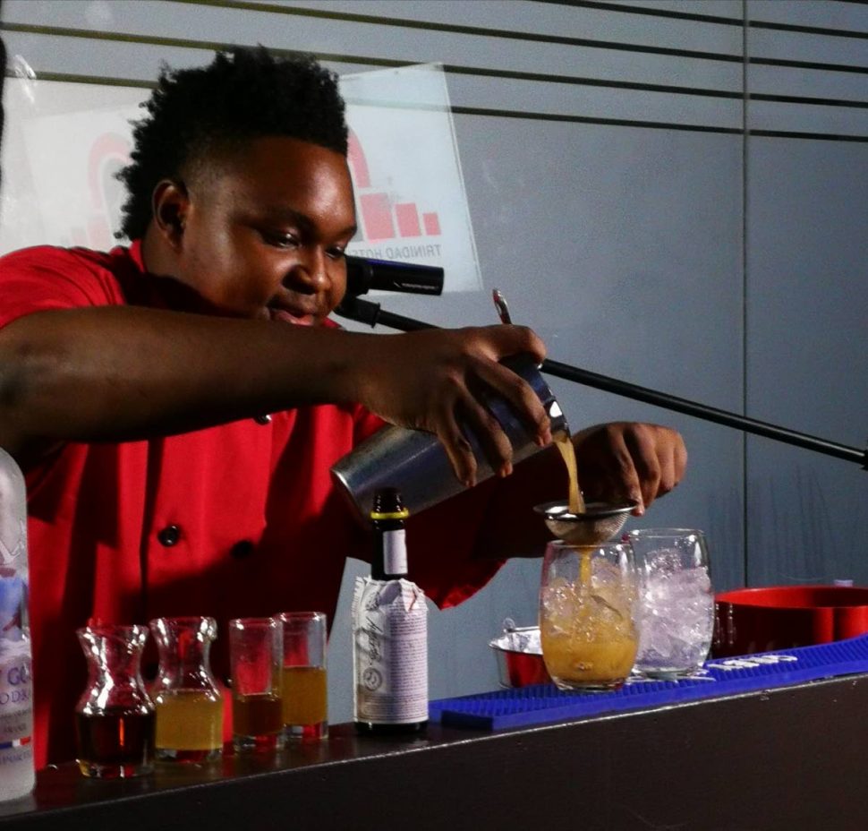 MR MIXER: Isaiah Trumpet mixes a cocktail en route to copping a silver medal for himself and team TT at a culinary competition held in Miami. The team also copped a gold and silver in other events.