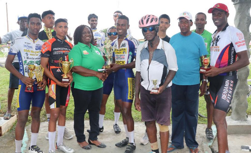 The prize winners pose with their trophy as Mayor of New Amsterdam, Winifred Haywood presents Balram Narine with his prize.
