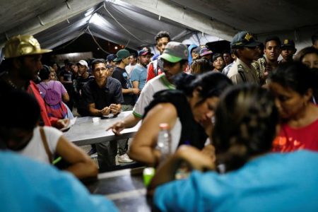 Venezuelan migrants queue at the Ecuadorian Peruvian border service center, to process their documents and be able to continue their journey, in the outskirts of Tumbes, Peru June 14, 2019. REUTERS/Carlos Garcia Rawlins