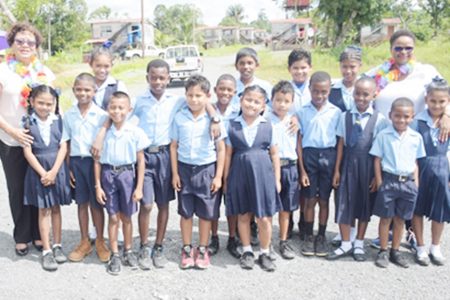Minister of Public Health Volda Lawrence (right) and Minister within the Ministry of Indigenous Peoples’ Affairs Valerie Garrido-Lowe (left) along with several students of the St. Mary’s Primary School, Region 7. (DPI photo)