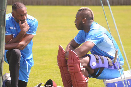 Andre Russell (right) chats with head coach Floyd Reifer during a recent net session. 