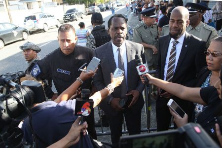 Acting National Security Minister Fitzgerald Hinds (centre) speaks to members of the media outside the Queen’s Park Oval yesterday. Also in picture are Police Commissioner, Gary Griffith, left and PS in the National Security Ministry, Vel Lewis.