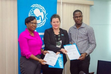 From left: Official from the Ministry of Social Protection, Tonni October; UNICEF Resident Representative to Guyana, Sylvie Fouet and Regional Health Officer Region 4, Dr. Quacy Jones with the signed document for the donated equipment. (DPI photo)