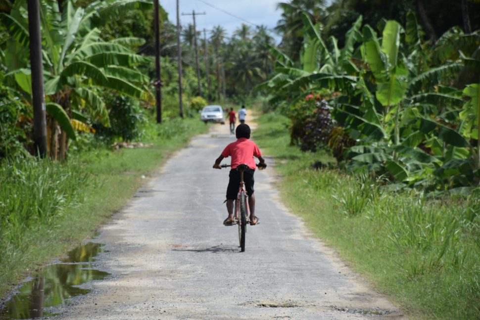 A Wakenaam lad rides his bicycle down one of the roads on the island (DPI photo)