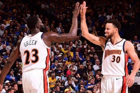 Draymond Green, left and Stephen Curry celebrate after their one-point win Monday night that kept their hopes of a three-peat  alive.