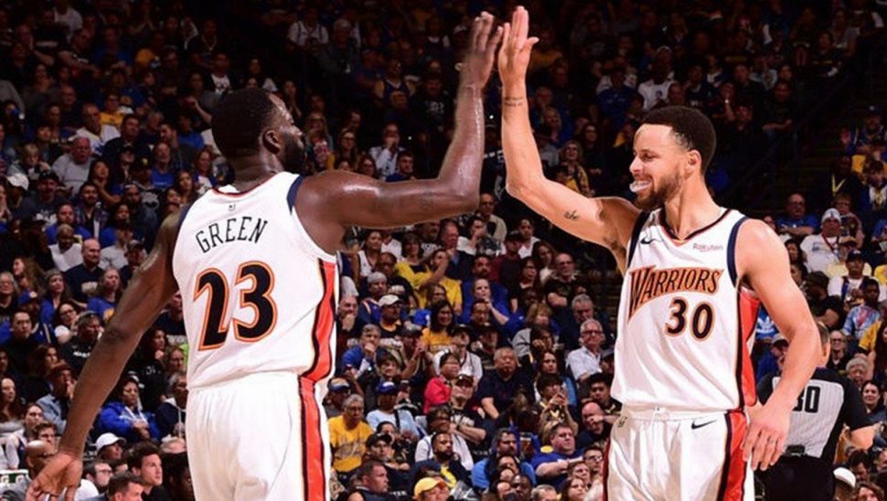 Draymond Green, left and Stephen Curry celebrate after their one-point win Monday night that kept their hopes of a three-peat  alive.