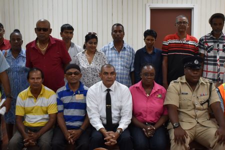 Minister of Business Haimraj Rajkumar (seated third, from left), Head of the Department of Consumer Affairs Muriel Tinnis (seated third, from right), along with Inspector Griffith (seated second, from right) and members of the Essequibo Coast Minibus Association and ranks of the Guyana Police Force after the meeting on Thursday. 