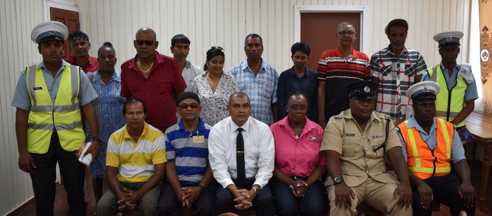 Minister of Business Haimraj Rajkumar (seated third, from left), Head of the Department of Consumer Affairs Muriel Tinnis (seated third, from right), along with Inspector Griffith (seated second, from right) and members of the Essequibo Coast Minibus Association and ranks of the Guyana Police Force after the meeting on Thursday. 