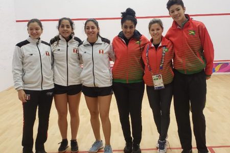 Guyana’s squash contingent (at right) with their Peruvian opponents after their contest yesterday.
