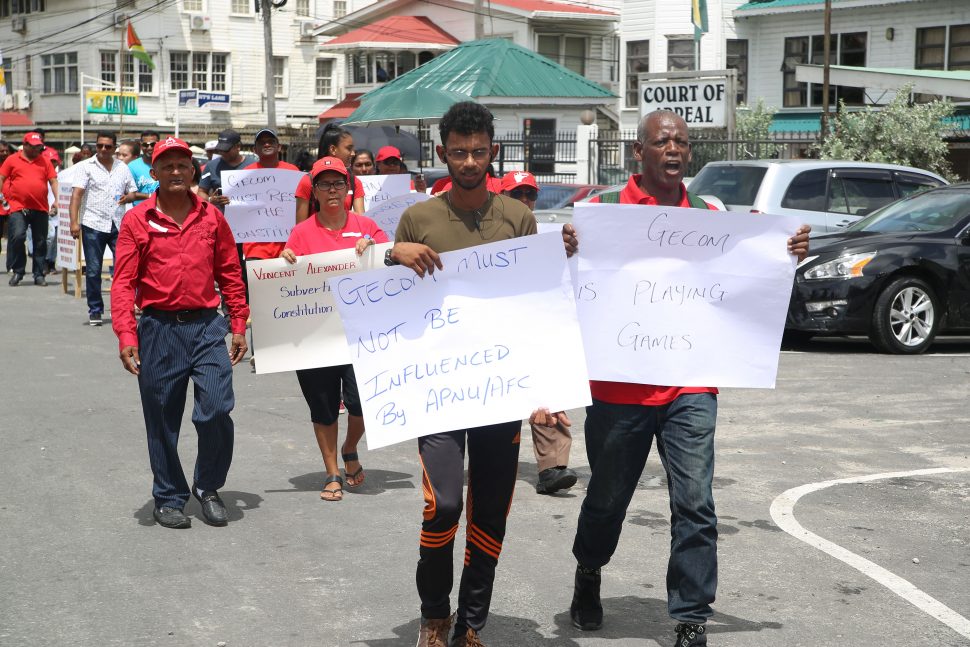 Some of the supporters of the PPP who protested near the GECOM headquarters yesterday for elections to be held. They also criticised the move to hold house-to-house registration. [Terrence Thompson photo) 