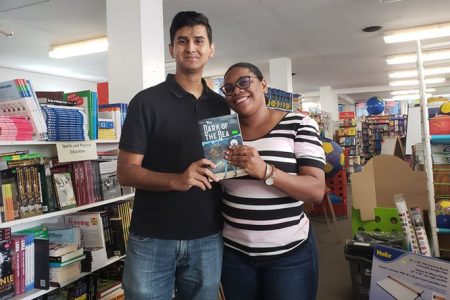 Imam Baksh (left) along with Dianne Henry after getting her book signed at the Austin’s Bookstore yesterday.