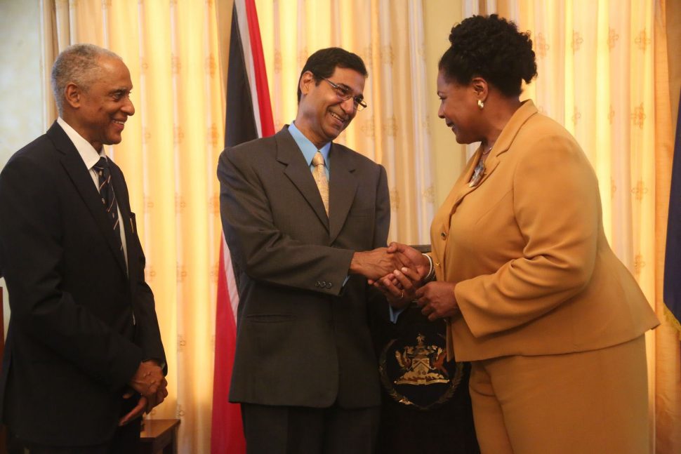 Justice Peter Jamadar, centre shakes hands with President Paula-Mae Weekes as Caribbean Court of Justice (CCJ) President Justice Adrian Saunders left looks on during the swearing-in ceremony at the Office of the President. 