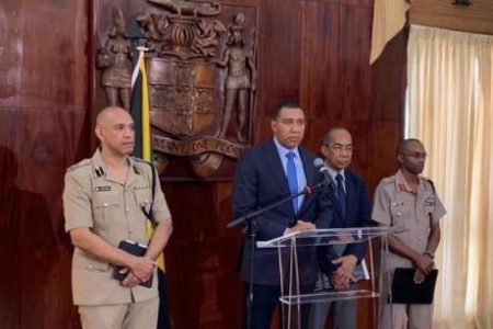 Prime Minister Andrew Holness is flanked by Police Commissioner Major General Antony Anderson (left), National Security Minister Dr Horace Chang (second right) and Chief of Staff of the Jamaica Defence Force, Lieutenant General Rocky Meade as he declares state of the emergency in St Andrew South Police Division yesterday morning at the Office of the Prime Minister in St Andrew