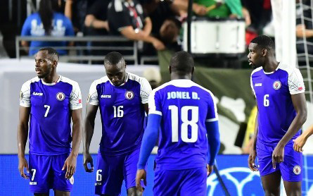 Haiti’s players look dejected after Mexico are awarded a 93rd minute penalty. 