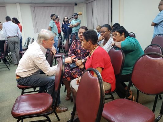 Concerned residents expressing their concerns to Country Readiness Manger, John Waldvogel (left) after the meeting concluded.
