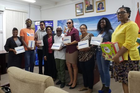 Representatives from GCOPD along with Minister Cathy Hughes (fourth from left) and Ganesh Singh (third from left) after the presentation ceremony yesterday.