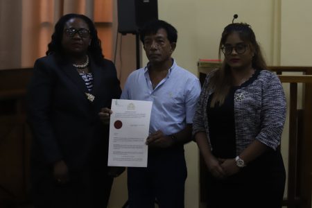 Dr. Rishee Thakur (centre) along with Chief Magistrate Ann McLennan (left) and former Magistrate Geeta Chandan-Edmond (right) after Thakur was sworn to lead the Commission of Inquiry into the fatal pirate attack that took place off the coast of Suriname last year. (Terrence Thompson photo)
