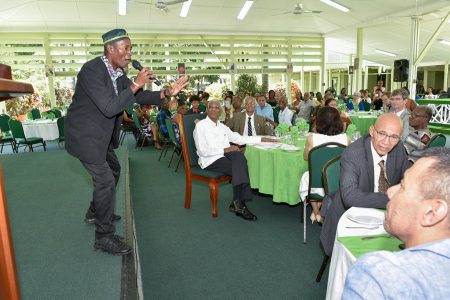 Calypsonian, Young Bill Rogers (left)  entertaining attendees today at the St. John Association Guyana annual luncheon at the Baridi Benab at State House. President David Granger (left of the singer) pays keen attention. (Ministry of the Presidency photo)