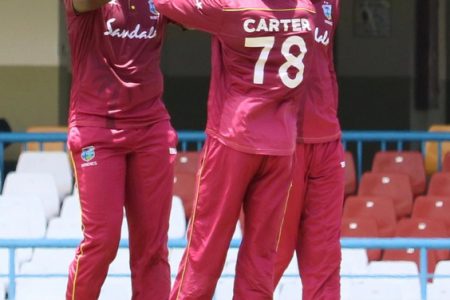 West Indies A team players  Raymon Reifer and Jonathan Carter celebrate the fall of a wicket.
