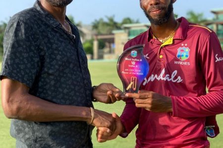 West Indies A captain Roston Chase, who top-scored with 84, gets his Man of-the-Match award from Sir Curtly Ambrose.
