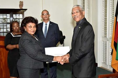 President David Granger presenting retired judge Claudette Singh with her Commission of Appointment as Senior Counsel in 2017. (Ministry of the Presidency photo)
