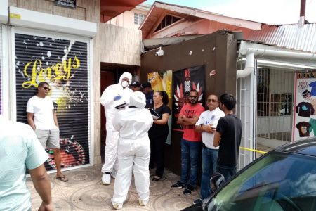Crime Scene Officers at the scene where local actor Raymond Choo Kong was murdered at his Arima home in the vicinity of the Police Station on Monday afternoon. -Photo: MICHEAL MONDEZIE 