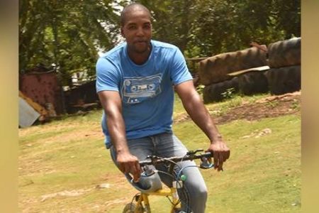 Thirty-sixyear- old David Daley riding his bicycle at his home in Northampton, St Elizabeth. (Photo: Gregory Bennett) 