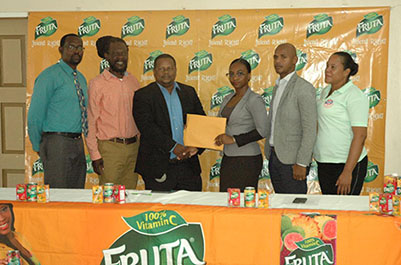 Fruta Conquerors executive committee member Jonelle D’Anjou receives the sponsorship cheque from GBI General Manager Samuel Arjoon [center] in the presence of several executives. Among the members of the presentation party are Club President Collin Gittens [2nd from right], Club Secretary Daniel [left] Thomas and Head-Coach Sampson Gilbert [2nd from left]