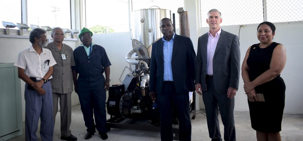 UG officials and others with the gasifier unit (UG photo)
