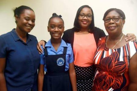 Portmore Missionary Preparatory School Principal Etta Walker (right)and sixth grade teacher Nicole Richards (left) share a photo op with Gabrielle Fennell (second left) and her mother Aneacia Neita. 