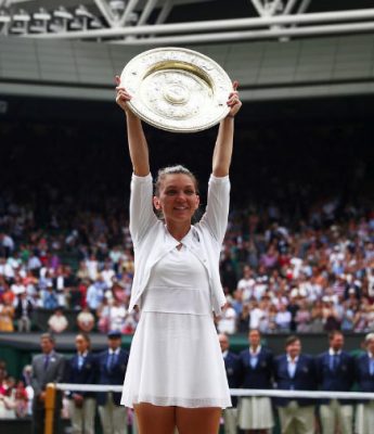 Simona Halep holds the Wimbledon Trophy aloft. (Reuter’s photo)
