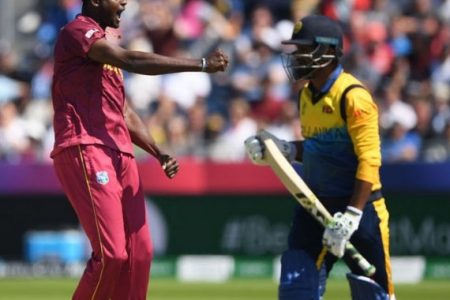 West Indies captain Jason Holder gets rid of Sri Lanka opener Dimuth  Karunaratne.
