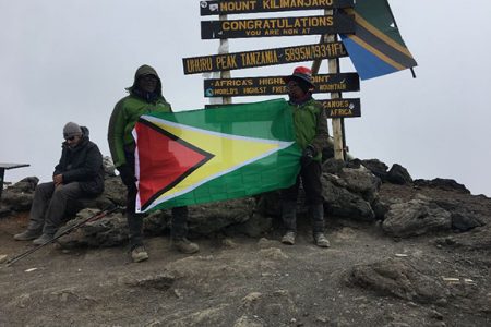 The couple at the peak with their Guyana flag  (Photo courtesy of Weusi Tafawa)
